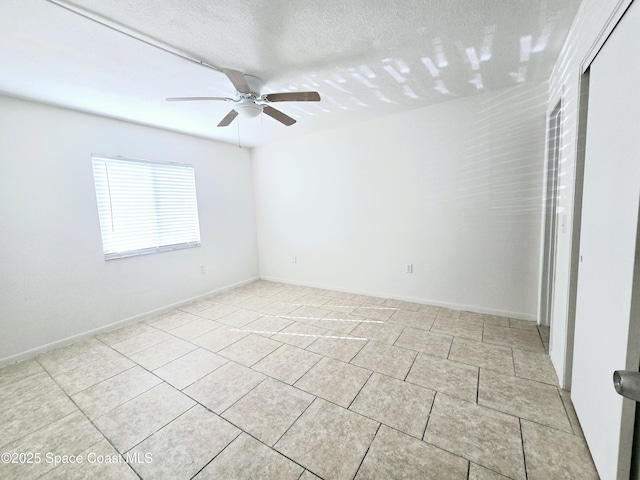 120 San Juan Cir, Melbourne, FL 32935 - unfurnished room featuring baseboards, a textured ceiling, a ceiling fan, and light tile patterned flooring
