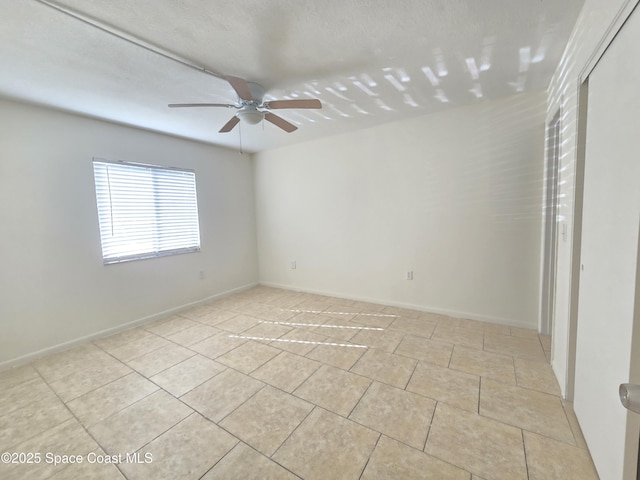 120 San Juan Cir, Melbourne, FL 32935 - empty room with light tile patterned floors, baseboards, and a ceiling fan