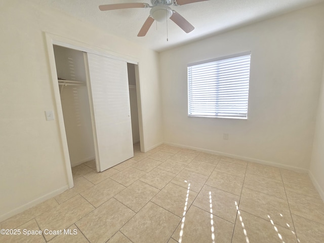 120 San Juan Cir, Melbourne, FL 32935 - unfurnished bedroom with light tile patterned floors, a closet, baseboards, and a ceiling fan