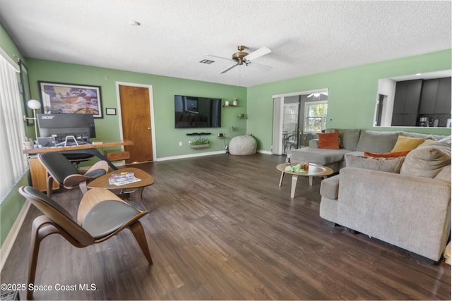 living room with wood finished floors, a textured ceiling, baseboards, visible vents, and ceiling fan