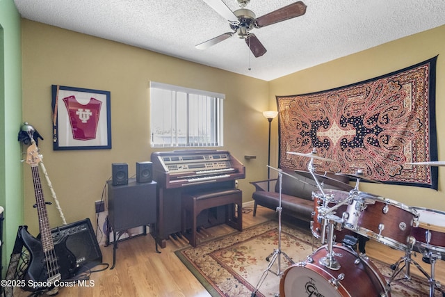 office featuring wood finished floors, ceiling fan, and a textured ceiling