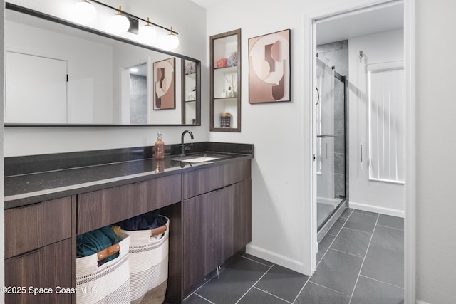 bathroom featuring vanity, baseboards, tile patterned floors, and a shower stall