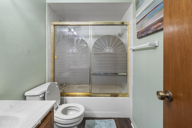 bathroom with wood finished floors, toilet, vanity, and shower / bath combination with glass door