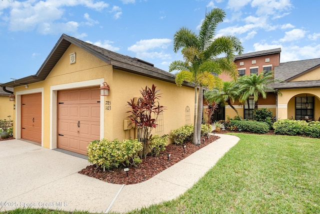 785 Luminary Cir Unit 103, Melbourne, FL 32901 - view of side of property with stucco siding, a lawn, concrete driveway, a garage, and a shingled roof