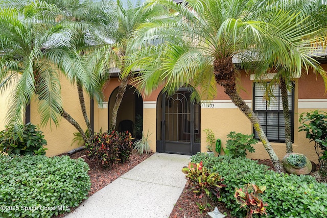 785 Luminary Cir Unit 103, Melbourne, FL 32901 - doorway to property featuring stucco siding
