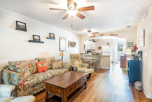 785 Luminary Cir Unit 103, Melbourne, FL 32901 - living area with ceiling fan, light wood-style floors, and baseboards