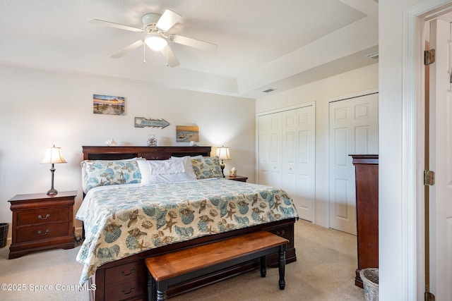 785 Luminary Cir Unit 103, Melbourne, FL 32901 - bedroom with light colored carpet, two closets, and ceiling fan