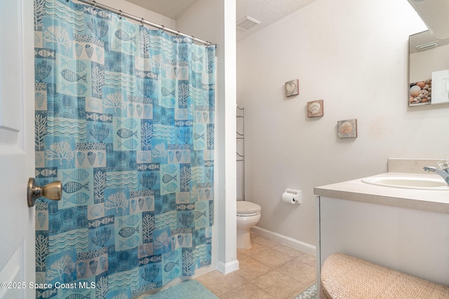 785 Luminary Cir Unit 103, Melbourne, FL 32901 - full bath featuring toilet, vanity, tile patterned flooring, baseboards, and a shower with shower curtain