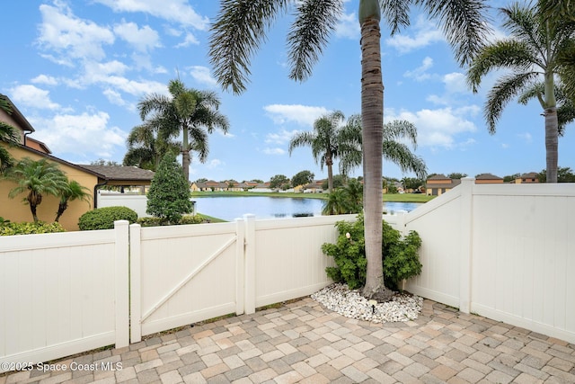 785 Luminary Cir Unit 103, Melbourne, FL 32901 - view of patio / terrace featuring a water view and a gate