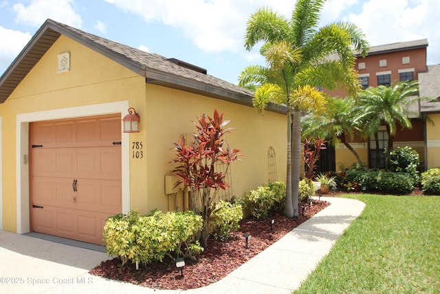 785 Luminary Cir Unit 103, Melbourne, FL 32901 - view of property exterior featuring stucco siding and a lawn