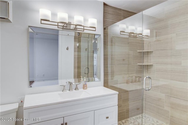 full bathroom with a stall shower, toilet, and vanity