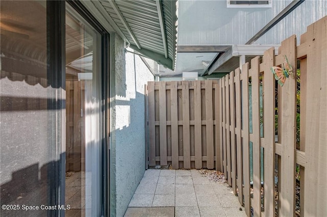 view of property exterior with fence and stucco siding
