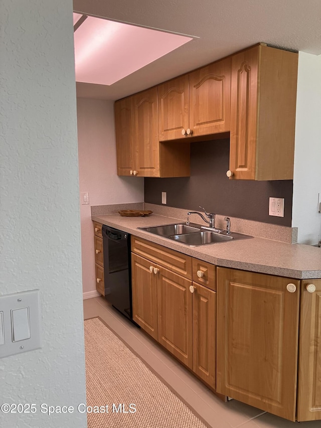 kitchen featuring light countertops, dishwasher, a sink, baseboards, and light tile patterned flooring