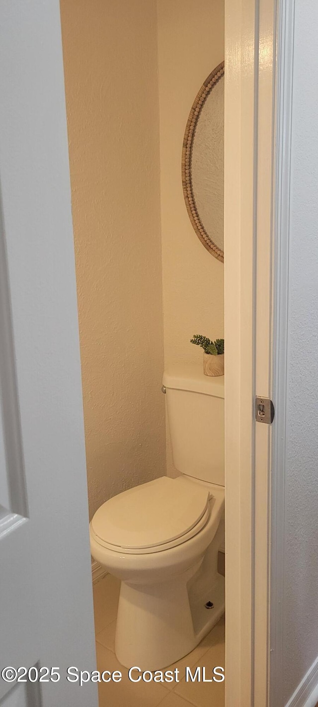 bathroom featuring tile patterned floors and toilet