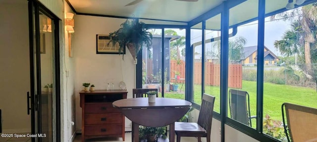 sunroom / solarium with a ceiling fan and a wall unit AC