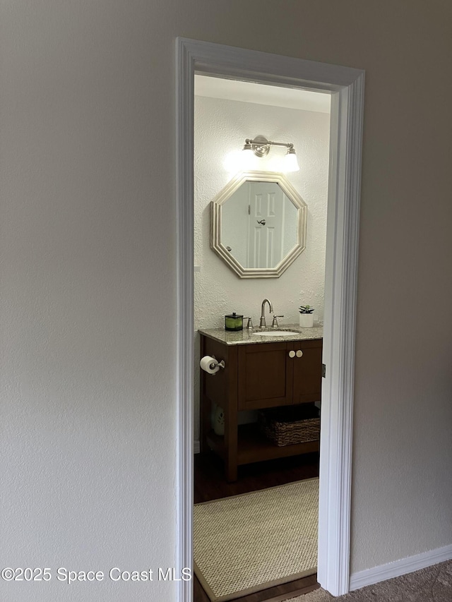 bathroom with baseboards and vanity