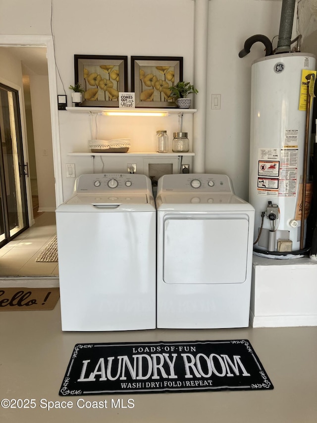 clothes washing area featuring water heater, separate washer and dryer, and laundry area