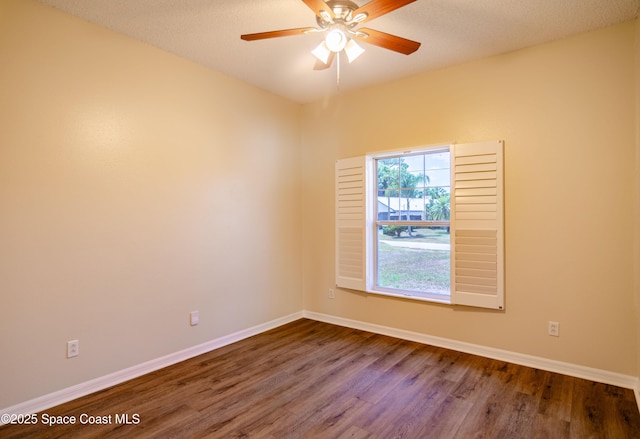 6697 Cecil Rd, Cocoa, FL 32927 - spare room with baseboards, ceiling fan, and dark wood-style floors