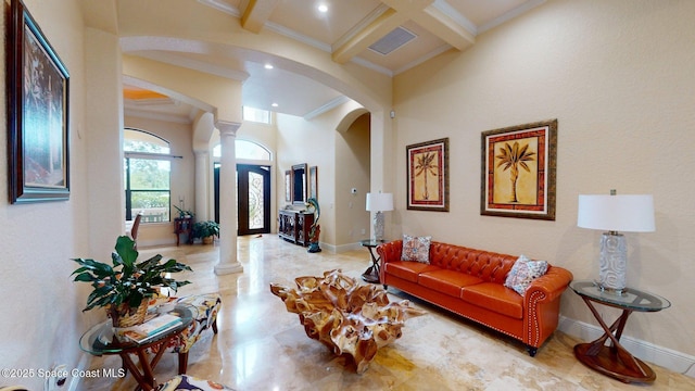 5454 Riveredge Dr, Titusville, FL 32780 - living area with arched walkways, decorative columns, crown molding, beamed ceiling, and baseboards
