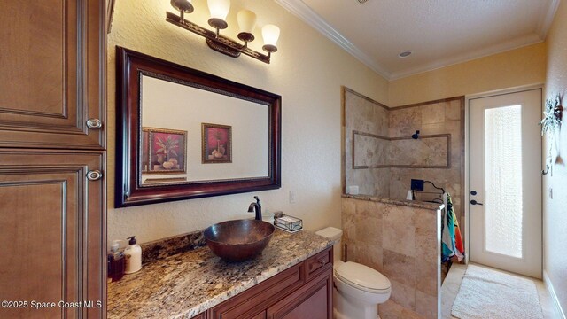 5454 Riveredge Dr, Titusville, FL 32780 - full bathroom with vanity, a tile shower, toilet, and crown molding