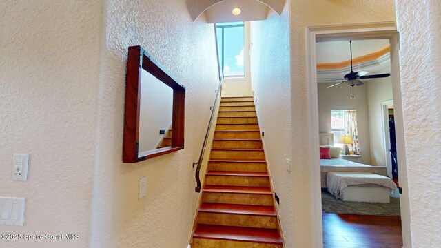 5454 Riveredge Dr, Titusville, FL 32780 - stairway with a textured wall, wood finished floors, and ceiling fan
