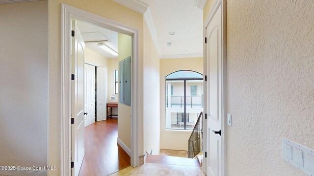5454 Riveredge Dr, Titusville, FL 32780 - hallway featuring crown molding, a textured wall, wood finished floors, and an upstairs landing
