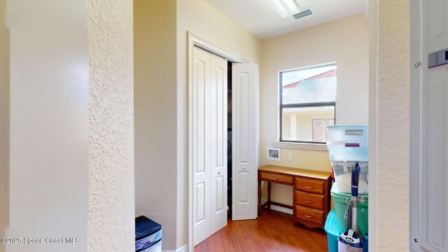 5454 Riveredge Dr, Titusville, FL 32780 - corridor featuring wood finished floors and a textured wall