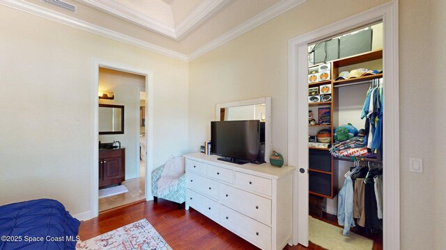 5454 Riveredge Dr, Titusville, FL 32780 - bedroom featuring dark wood-style floors, crown molding, a closet, a spacious closet, and ensuite bathroom