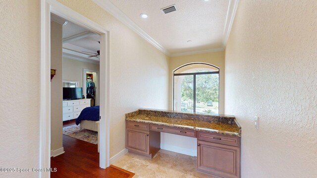 5454 Riveredge Dr, Titusville, FL 32780 - bathroom with crown molding, a textured wall, a ceiling fan, wood finished floors, and baseboards