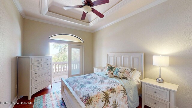 5454 Riveredge Dr, Titusville, FL 32780 - bedroom featuring access to outside, a raised ceiling, ornamental molding, dark wood-type flooring, and a ceiling fan