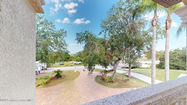 5454 Riveredge Dr, Titusville, FL 32780 - view of grassy yard featuring curved driveway