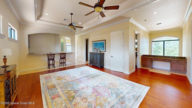 5454 Riveredge Dr, Titusville, FL 32780 - bedroom featuring arched walkways, hardwood / wood-style floors, ornamental molding, and recessed lighting