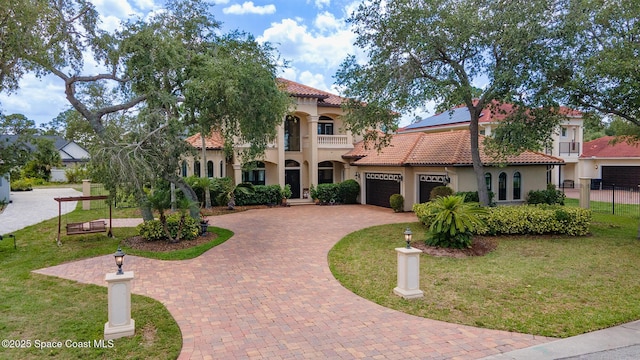 5454 Riveredge Dr, Titusville, FL 32780 - mediterranean / spanish-style house featuring decorative driveway, a tile roof, stucco siding, and an attached garage