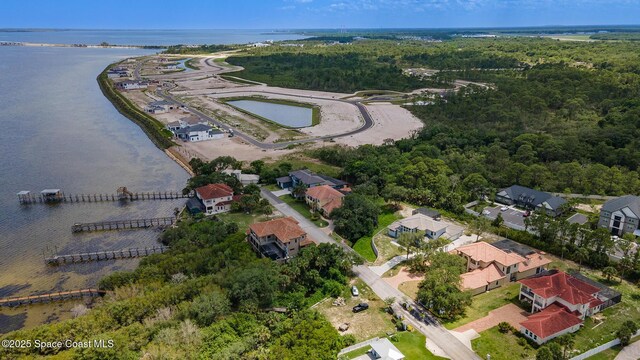 5454 Riveredge Dr, Titusville, FL 32780 - aerial perspective of suburban area with a nearby body of water and a heavily wooded area