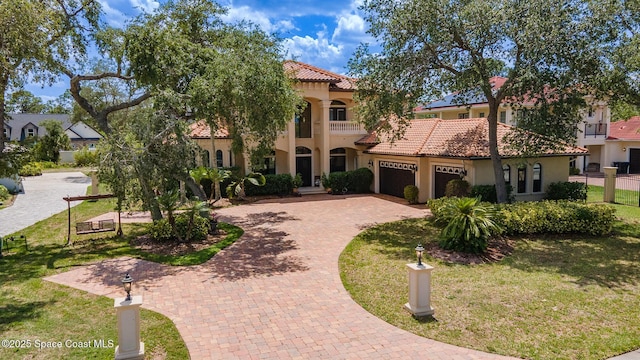 5454 Riveredge Dr, Titusville, FL 32780 - mediterranean / spanish home with a tile roof, decorative driveway, an attached garage, and stucco siding