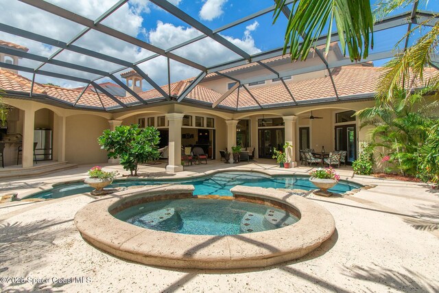5454 Riveredge Dr, Titusville, FL 32780 - view of swimming pool featuring ceiling fan, a patio, a lanai, and a pool with connected hot tub