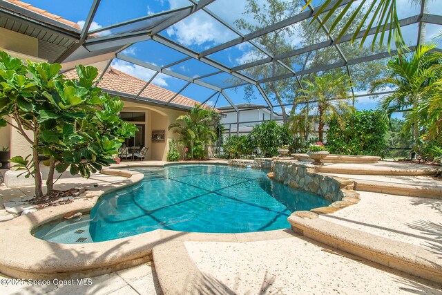 5454 Riveredge Dr, Titusville, FL 32780 - swimming pool with a patio and glass enclosure
