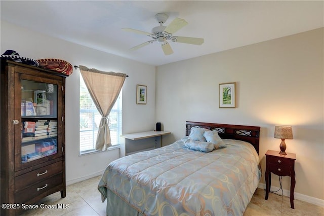 bedroom with light tile patterned floors, ceiling fan, and baseboards