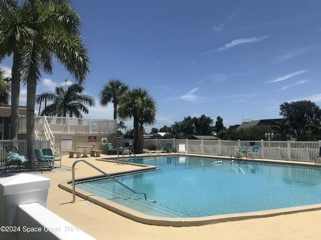 pool featuring a patio and fence