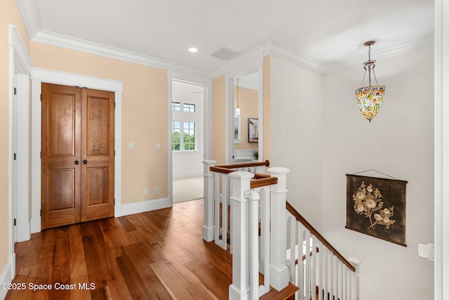 7021 S Tropical Trl, Merritt Island, FL 32952 - hallway with an upstairs landing, dark wood-style flooring, crown molding, baseboards, and recessed lighting