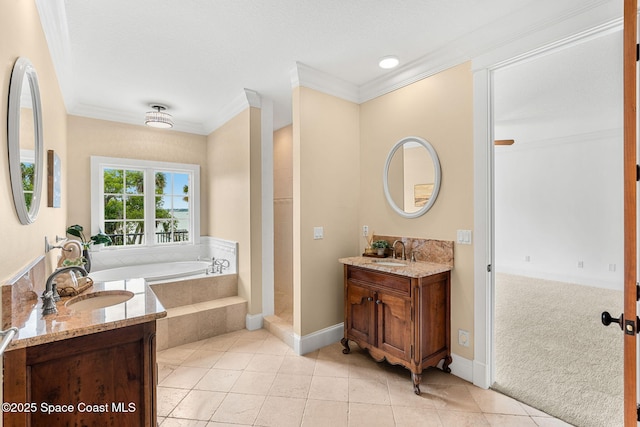 7021 S Tropical Trl, Merritt Island, FL 32952 - bathroom with a bath, ornamental molding, two vanities, baseboards, and tile patterned floors