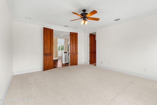 7021 S Tropical Trl, Merritt Island, FL 32952 - unfurnished room with carpet flooring, ceiling fan, crown molding, and baseboards