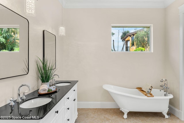 7021 S Tropical Trl, Merritt Island, FL 32952 - bathroom with baseboards, plenty of natural light, a soaking tub, double vanity, and crown molding