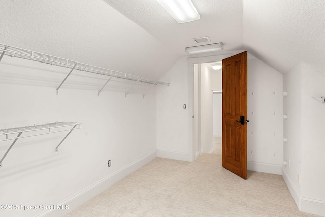 7021 S Tropical Trl, Merritt Island, FL 32952 - walk in closet featuring lofted ceiling and light carpet