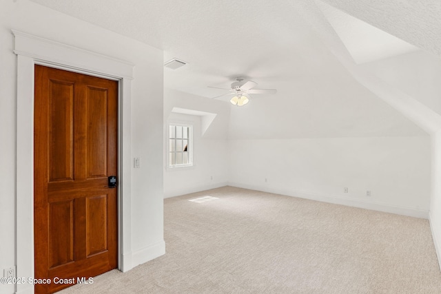 7021 S Tropical Trl, Merritt Island, FL 32952 - bonus room featuring light colored carpet, a ceiling fan, baseboards, and lofted ceiling