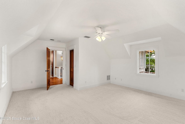 7021 S Tropical Trl, Merritt Island, FL 32952 - additional living space featuring vaulted ceiling, light colored carpet, a ceiling fan, and baseboards