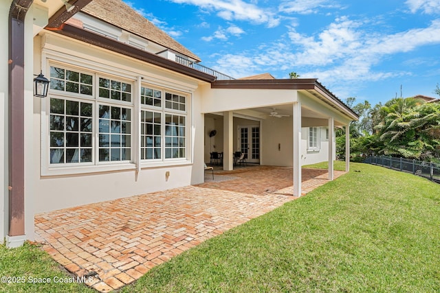 7021 S Tropical Trl, Merritt Island, FL 32952 - rear view of house featuring stucco siding, a ceiling fan, and a patio