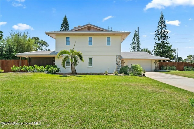 view of front of house with concrete driveway, stucco siding, a front yard, fence, and a garage