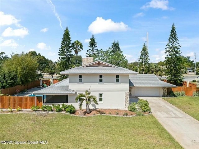 view of front of property featuring fence, a front lawn, concrete driveway, and an attached garage