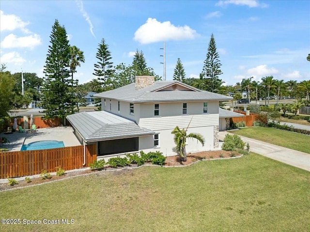 view of side of home with concrete driveway, a yard, stucco siding, and fence